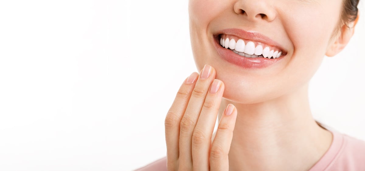 Perfect healthy teeth smile of a young woman. Teeth whitening. Dental clinic patient.