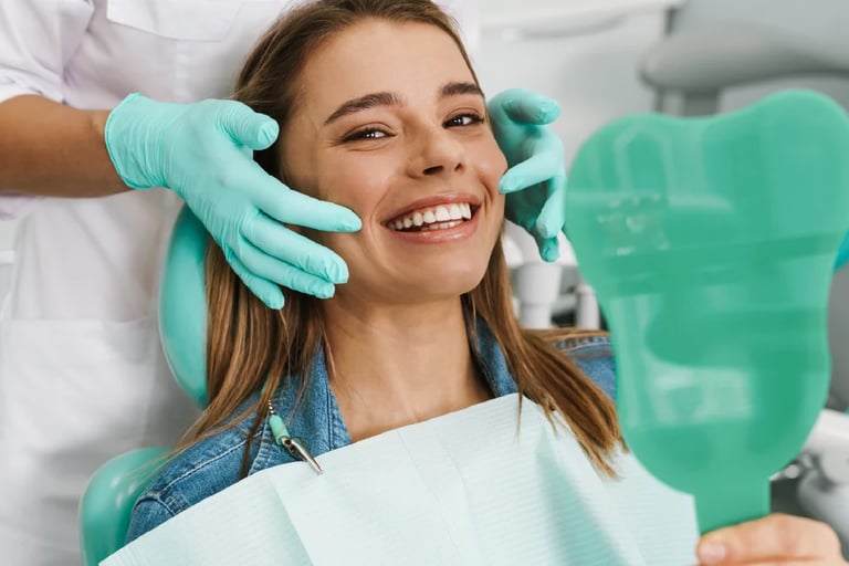 Woman smiling during dental examination while dentist in turquoise gloves adjusts her face in treatment chair